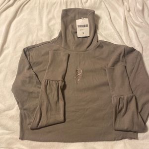 Embroidered rose turtle neck.